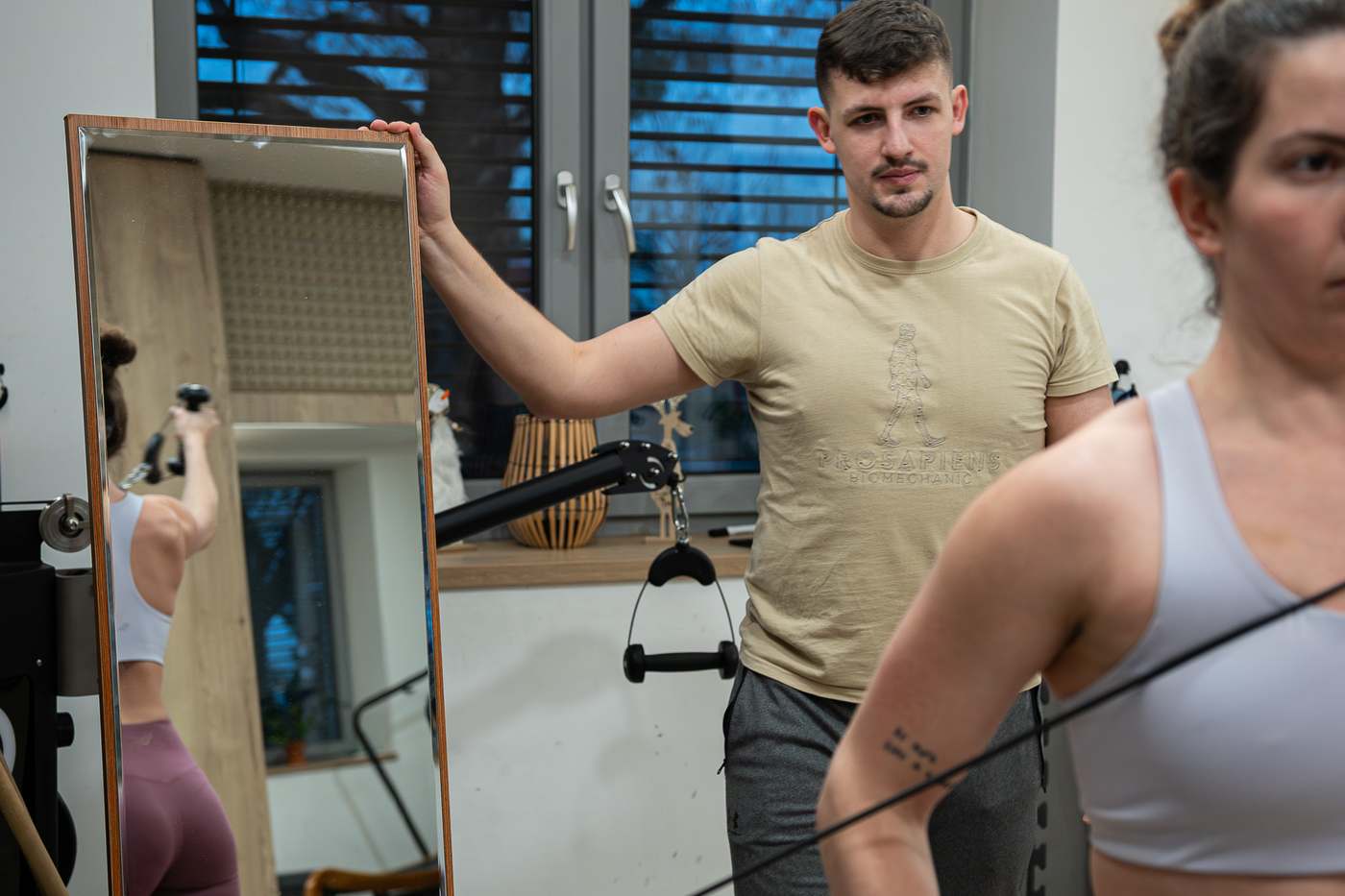 Trenér sleduje klientku u zrcadla